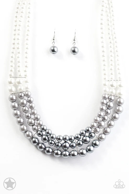 Silver beaded necklace and earrings on a white background
