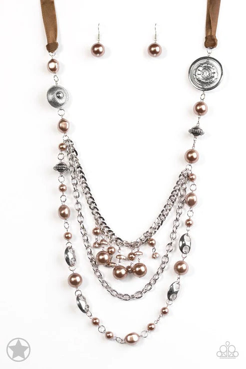 Necklace and earrings set with pearls and metal beads on a white background