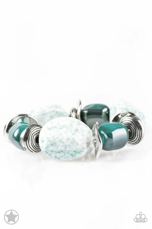 Bracelet with green and white beads on a white background