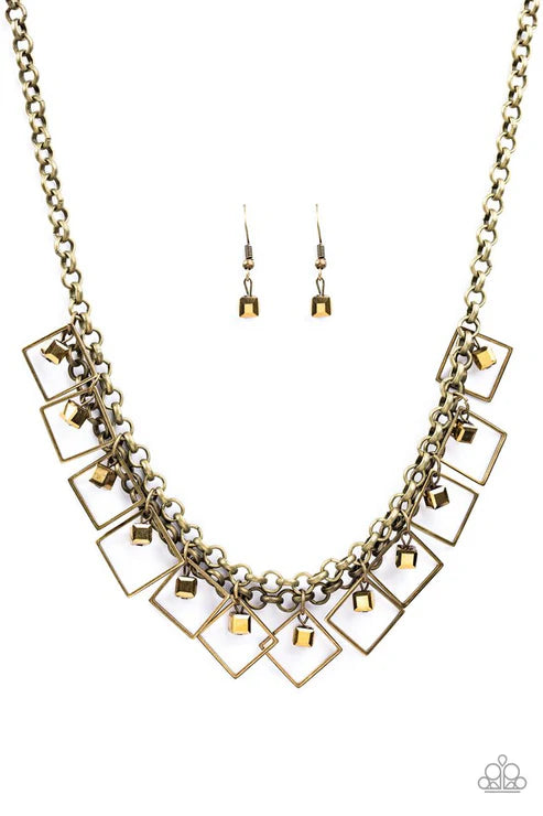 Gold chain necklace and earrings on a white background
