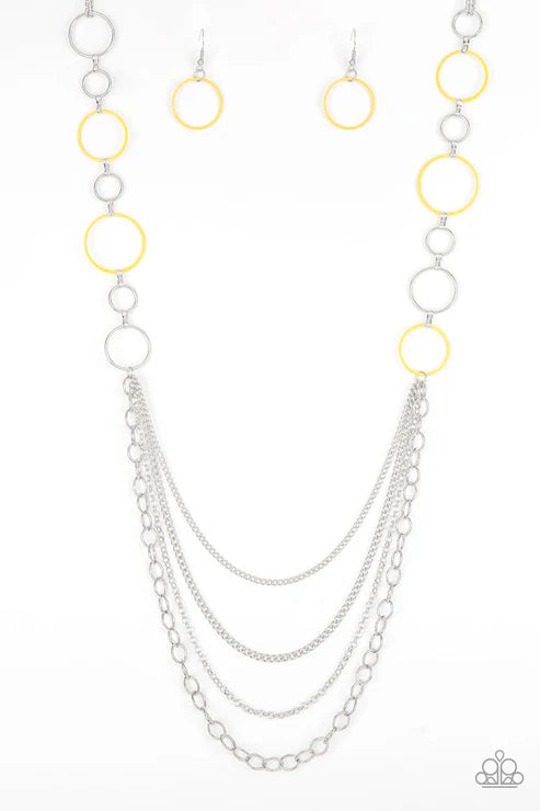 Necklace with layered chains and circular accents on a white background