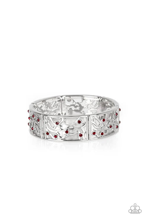 Silver ring with red gemstones on a white background