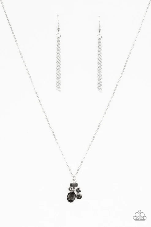 Silver necklace with a black pendant on a white background