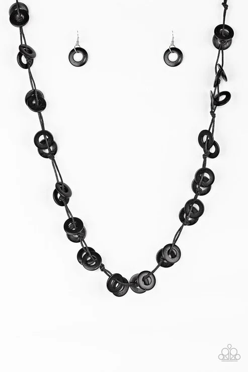 Black beaded necklace and earrings on a white background