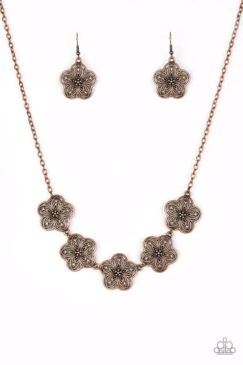 Jewelry set with floral-patterned necklace and earrings on a white background