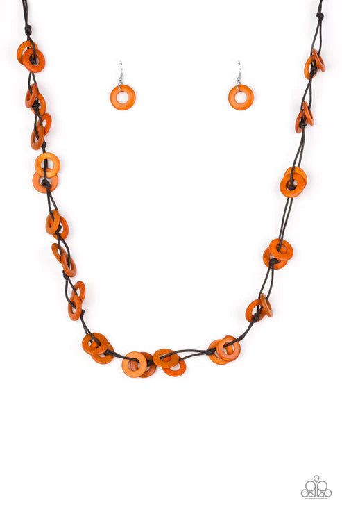 Necklace and earrings set with orange and black circular beads on a white background