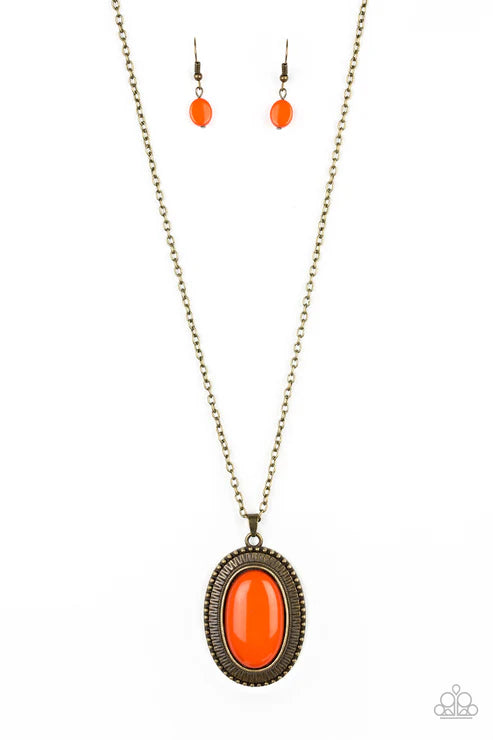 Necklace with orange pendant and matching earrings on a white background