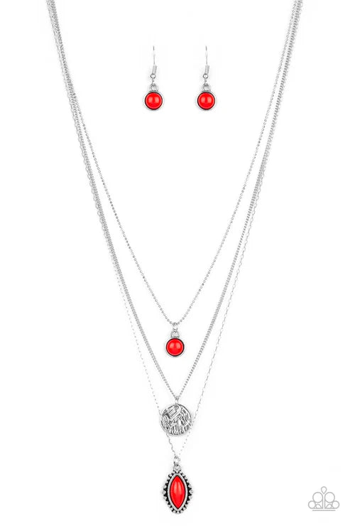 Silver necklace with red pendants and matching earrings on a white background