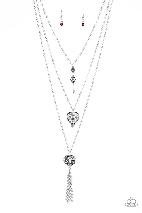 Layered silver necklaces with heart and tassel pendants on a white background