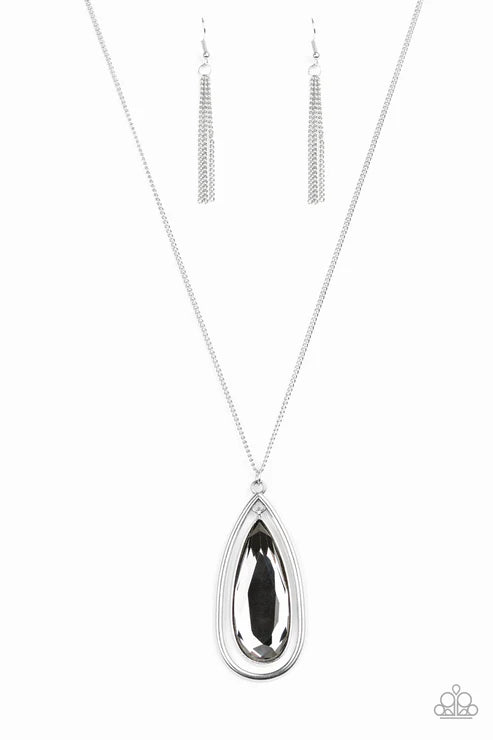 Teardrop-shaped silver pendant necklace and matching earrings on a white background
