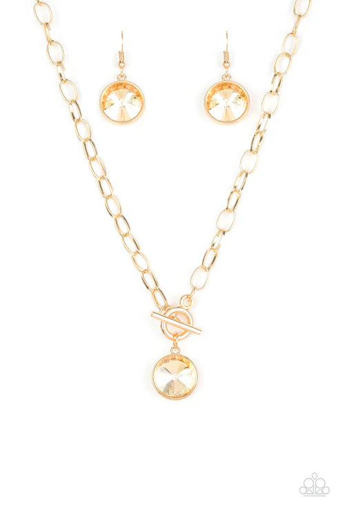 Gold necklace and earrings set on a white background