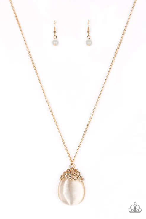 Necklace and earrings set with pearl-like pendant on a white background