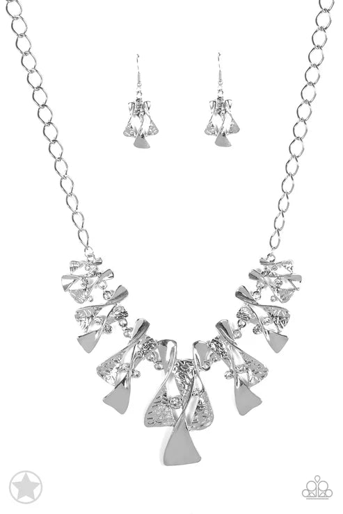 Silver necklace and earrings set on a white background