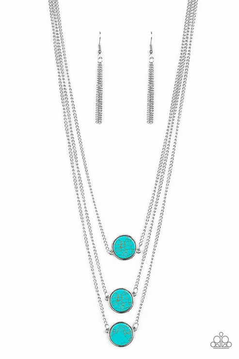 Turquoise pendant necklace and earrings on a white background