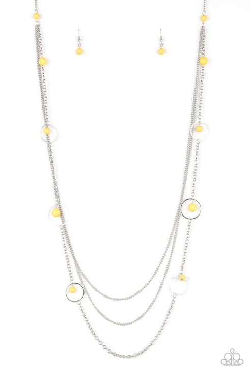 Multi-layered necklace with yellow beads on a white background