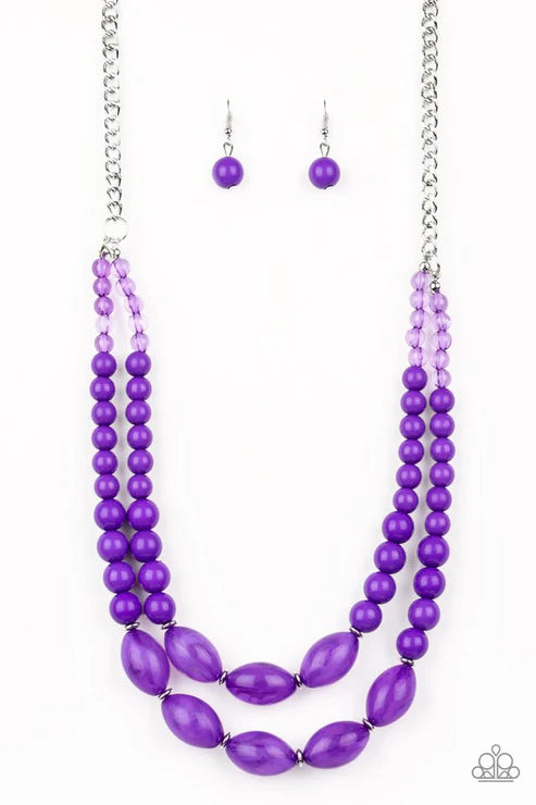 Purple beaded necklace and earrings on a white background