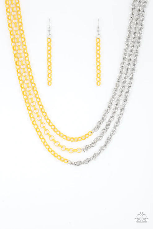 Two necklaces, one yellow and one silver, on a white background