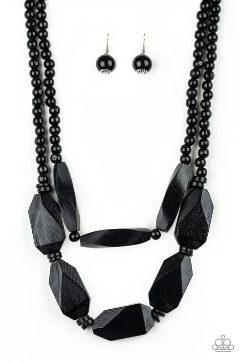 Black beaded necklace and earrings on a white background