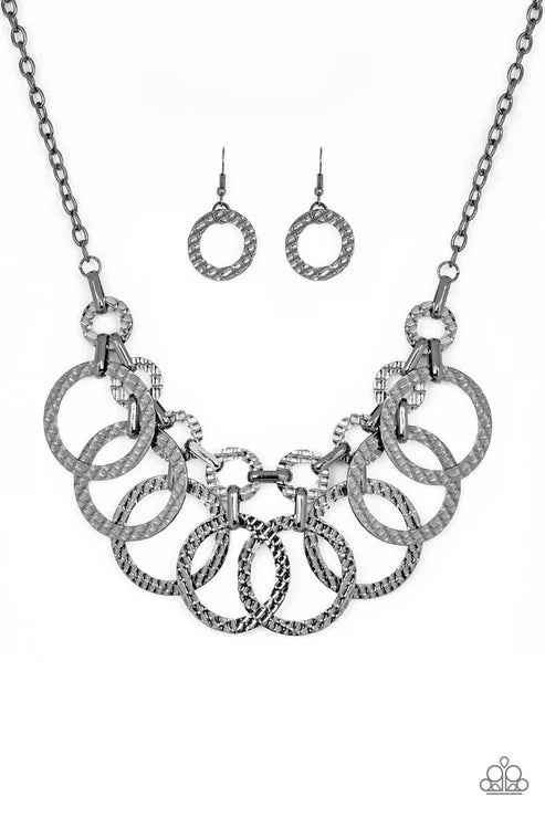 Silver necklace and earrings set on a white background