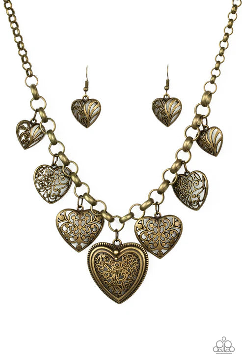 Bronze heart-shaped necklace and earrings on a white background