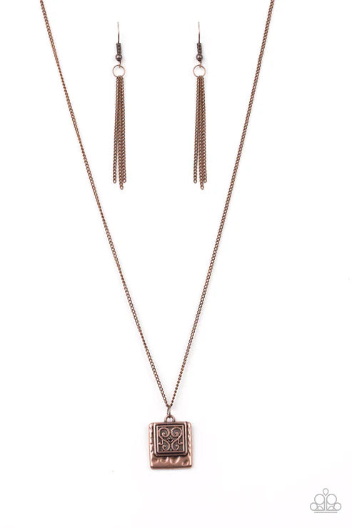 Rose gold necklace and earrings on a white background