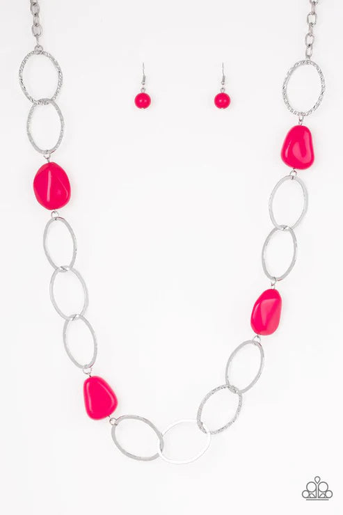Necklace and earrings with pink stones on a white background