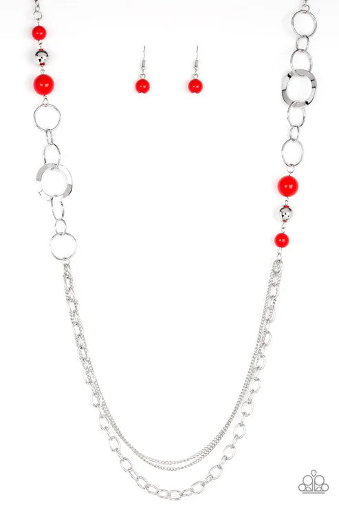 Silver chain necklace with red beads and matching earrings on a white background