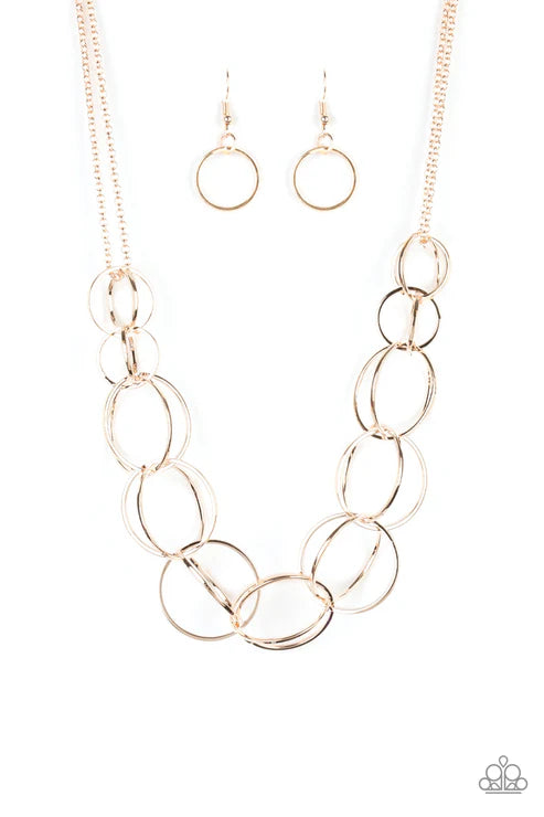 Gold chain necklace and earrings on a white background