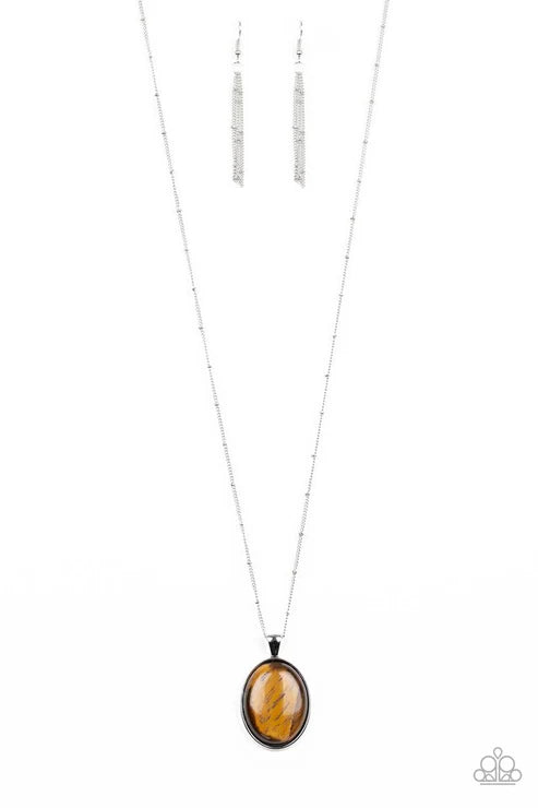 Necklace with amber pendant and matching earrings on a white background