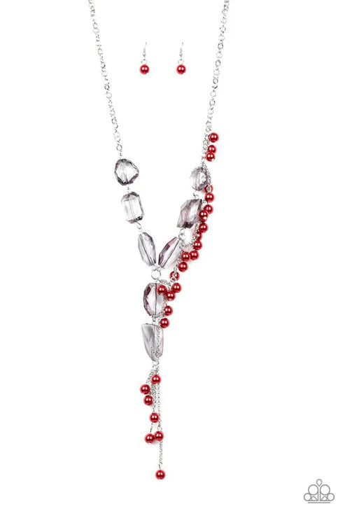 Necklace and earrings with red beads and silver accents on a white background