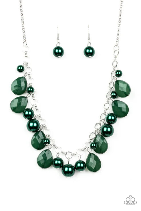 Green beaded necklace and earrings on a white background