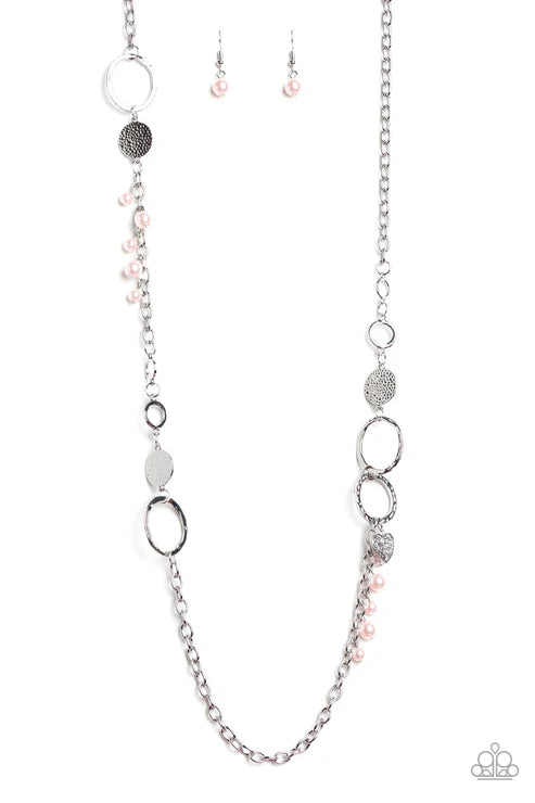 Silver necklace with circular and oval beads on a white background