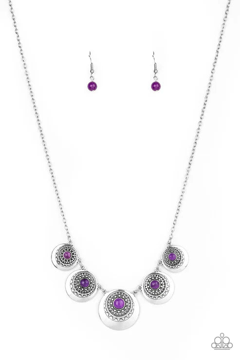 Silver necklace with purple gemstones on a white background