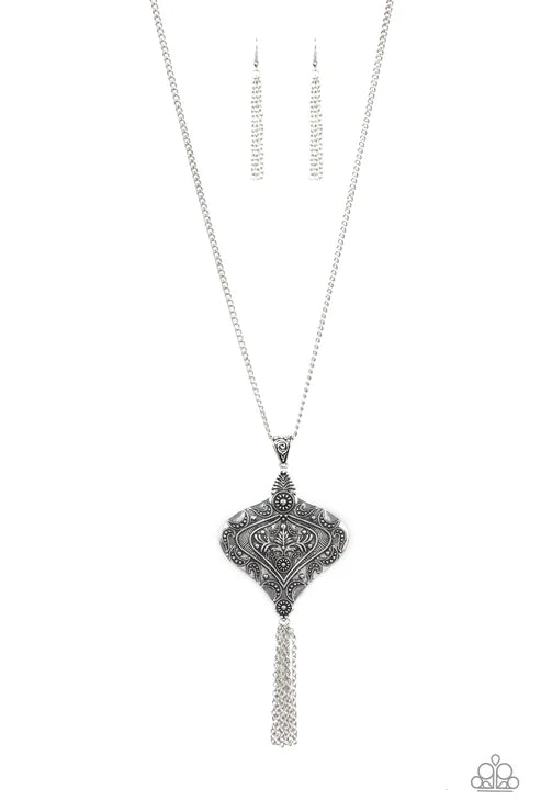 Silver necklace with intricate pendant on a white background