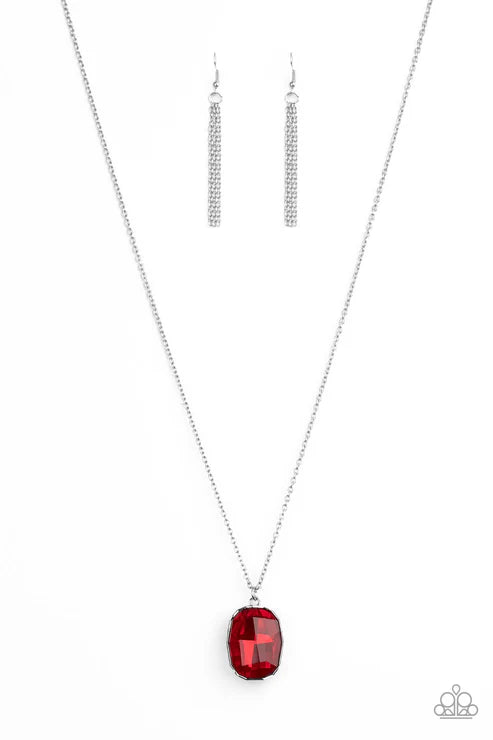 Silver necklace with a red pendant and matching earrings on a white background