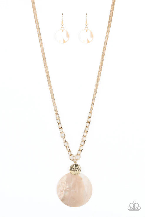 Necklace with a large pink stone pendant and matching earrings on a white background