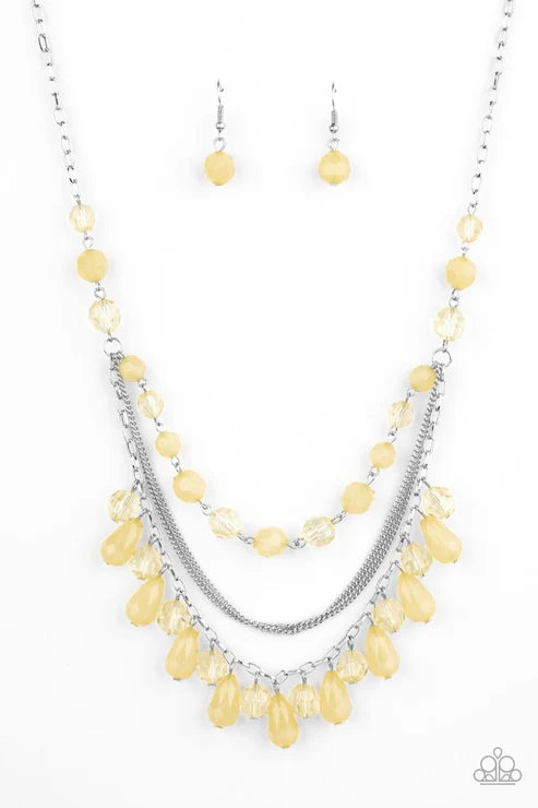 Necklace with yellow beads and silver chain on a white background