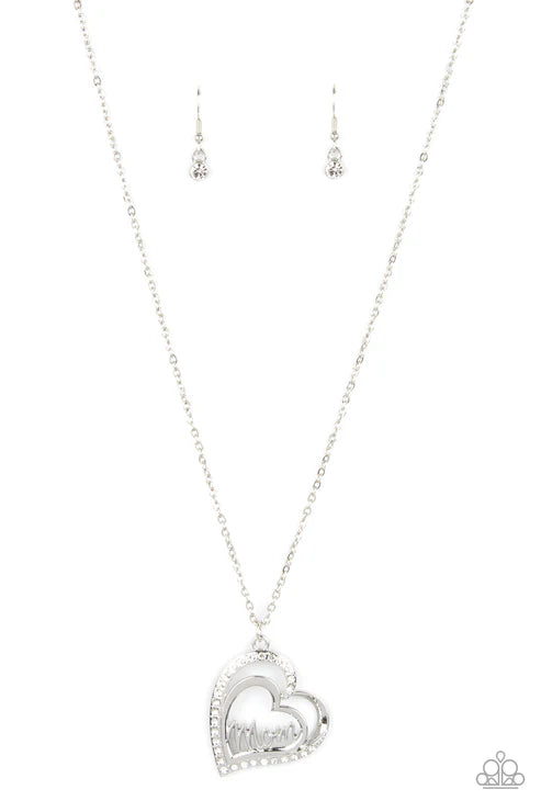 Silver heart-shaped necklace and earrings on a white background