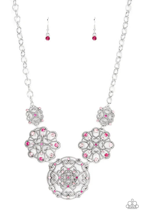Silver necklace with pink gemstones on a white background