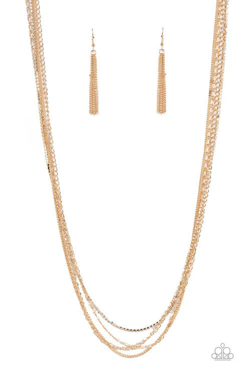 Gold necklace and earrings set on a white background