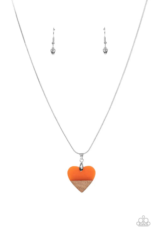 Necklace with orange and beige heart pendant and matching earrings on a white background
