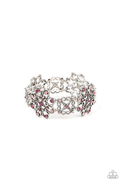 Silver bracelet with pink stones on a white background