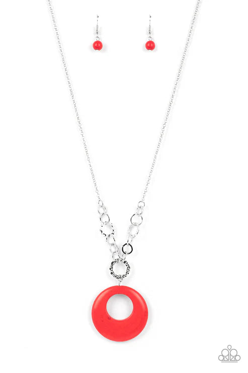 Necklace with a red circular pendant and matching earrings on a white background