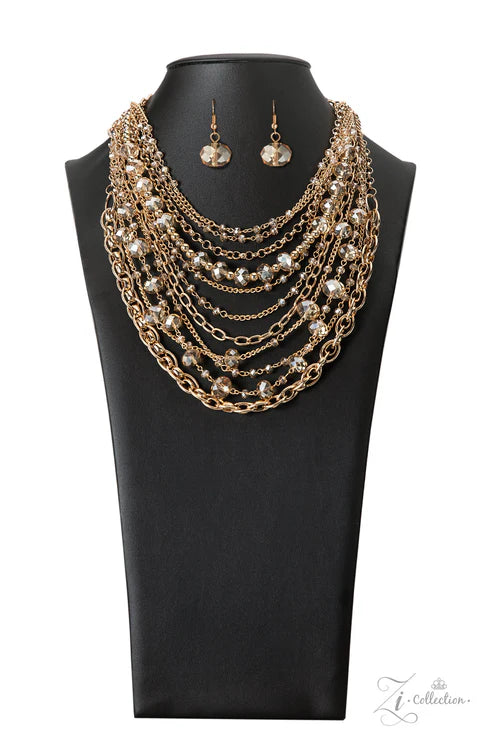 Jewelry set with gold necklace and earrings on a black mannequin bust.