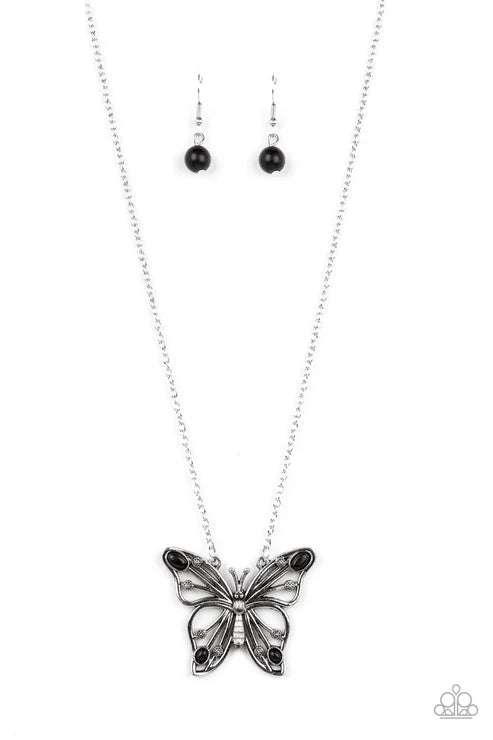 Butterfly necklace and earrings on a white background