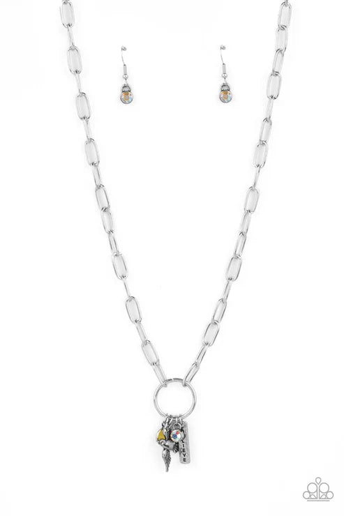 Silver necklace with pendant and matching earrings on a white background