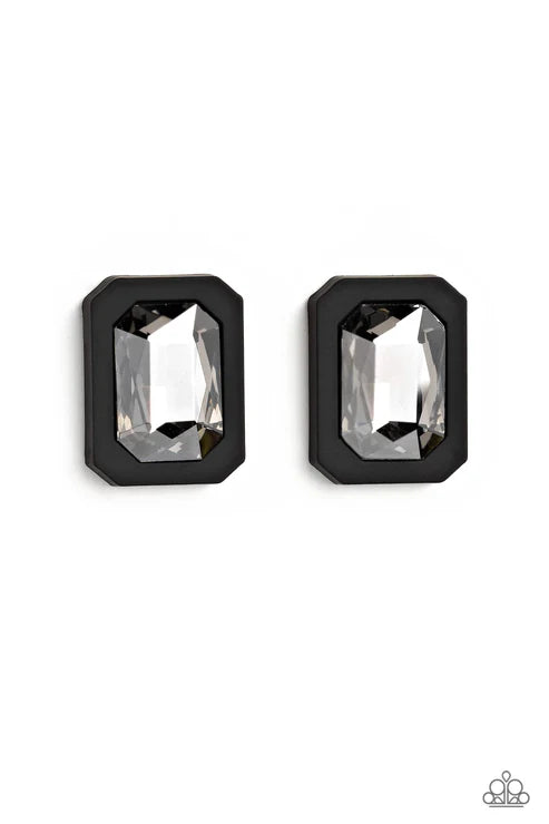 A pair of black rectangular stud earrings with faceted clear crystal centers, displayed on a clean white background.