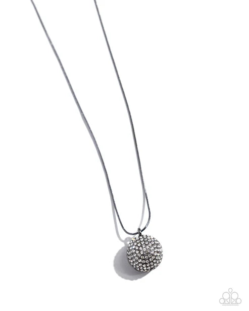 Silver necklace with a round, beaded pendant on a white background