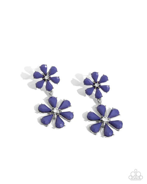 Pair of blue flower-shaped earrings on a white background