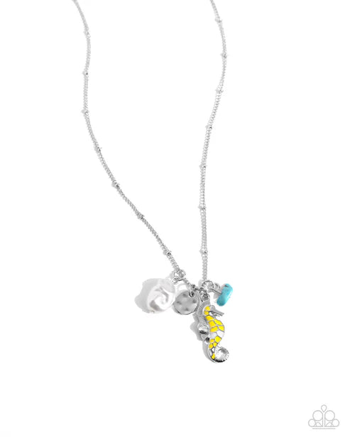 Necklace with seahorse charm on a white background